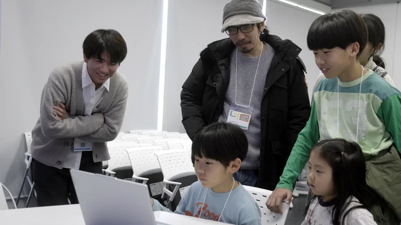 A family listening to a university student while looking at a laptop