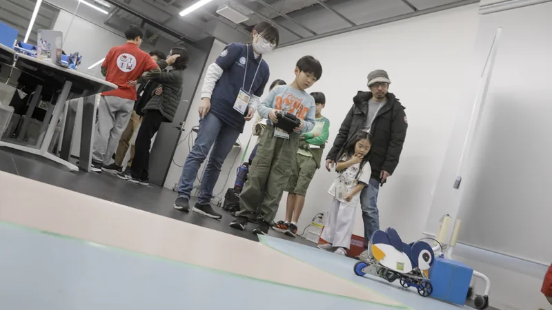 A child operating a penguin-shaped robot with staff